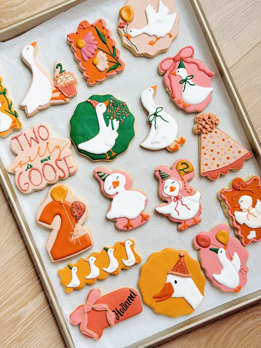 Goose themed second birthday cookies with party hats, balloons and Two Silly is Our Goose lettering